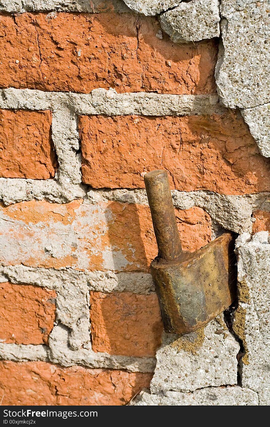 Old brickwall with rusty hinge