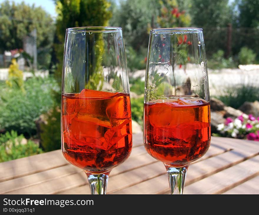 Two red drinks on a table in the nature