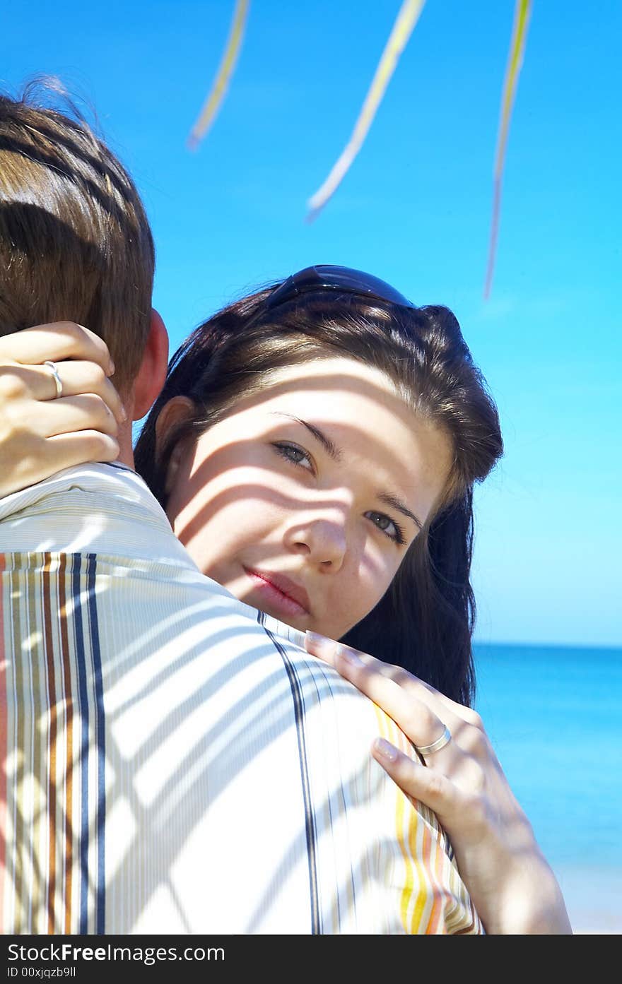 A portrait of attractive couple having date on the beach. A portrait of attractive couple having date on the beach