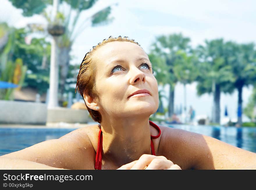 Portrait of nice young woman relaxing in swimming pool. Portrait of nice young woman relaxing in swimming pool