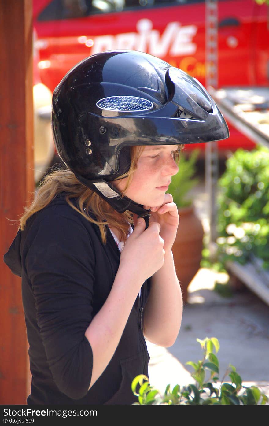 Young girl wearing a helmet. Young girl wearing a helmet