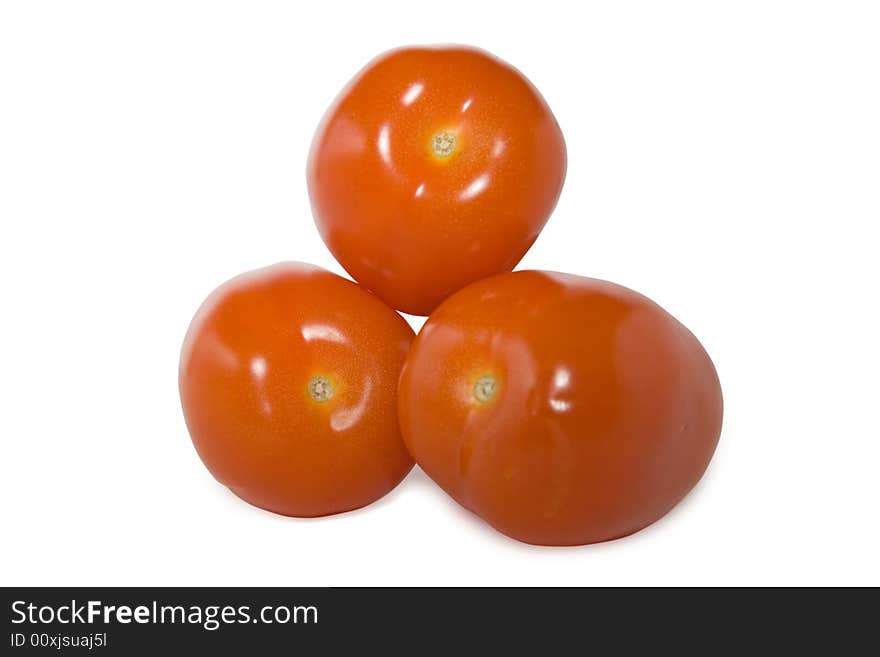 An isolated photo of three red tomatoes