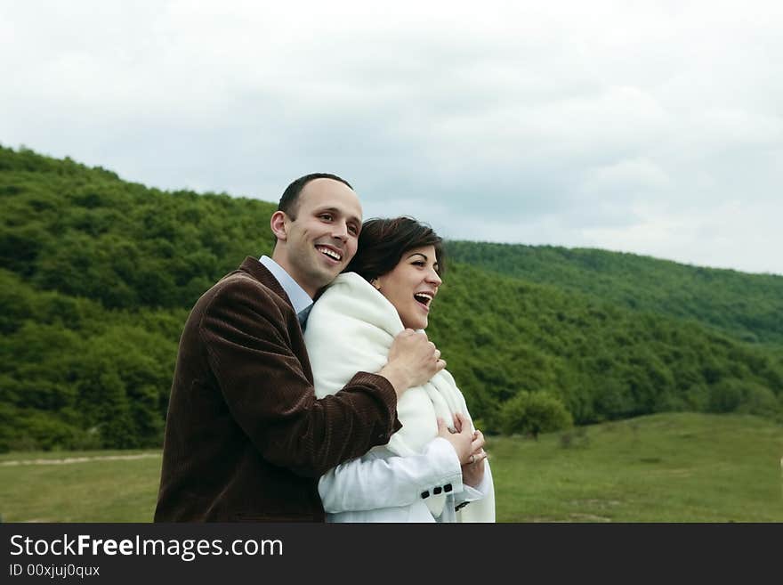 Young happy couple holding tight smiling outdoors