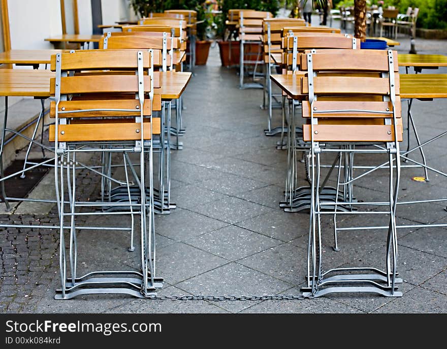 Small empty summer cafe with collapsible wooden chairs and tables. Small empty summer cafe with collapsible wooden chairs and tables