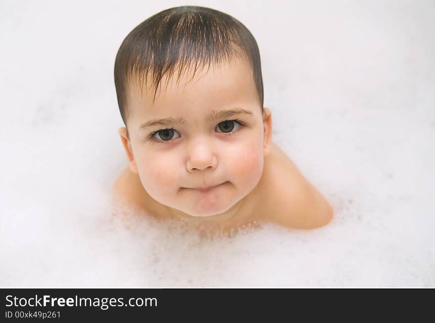 Thoughtful baby in foam (high key)