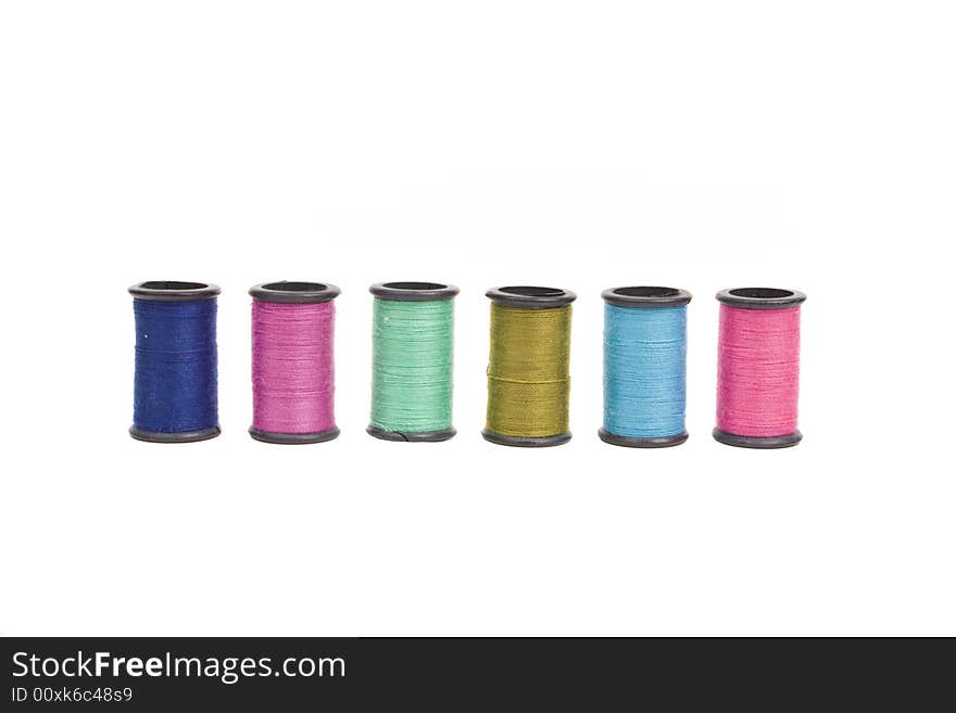 Spools of thread in a row