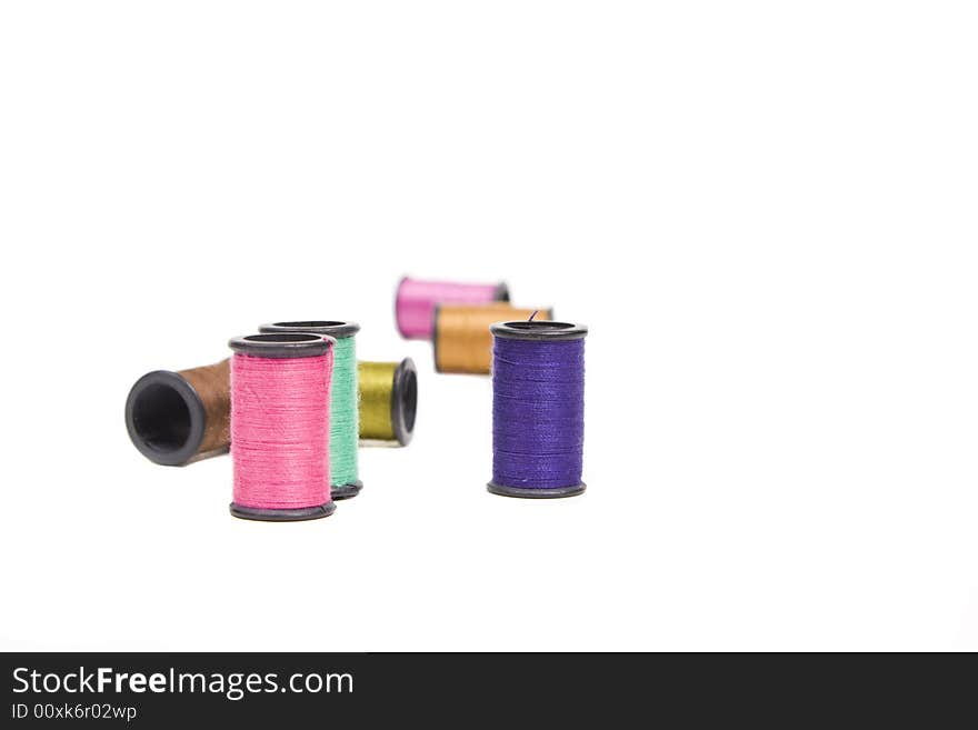 Spools of thread strewn about with copy space. Spools of thread strewn about with copy space