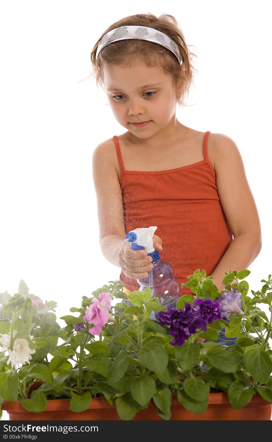 Young girl watering a flower