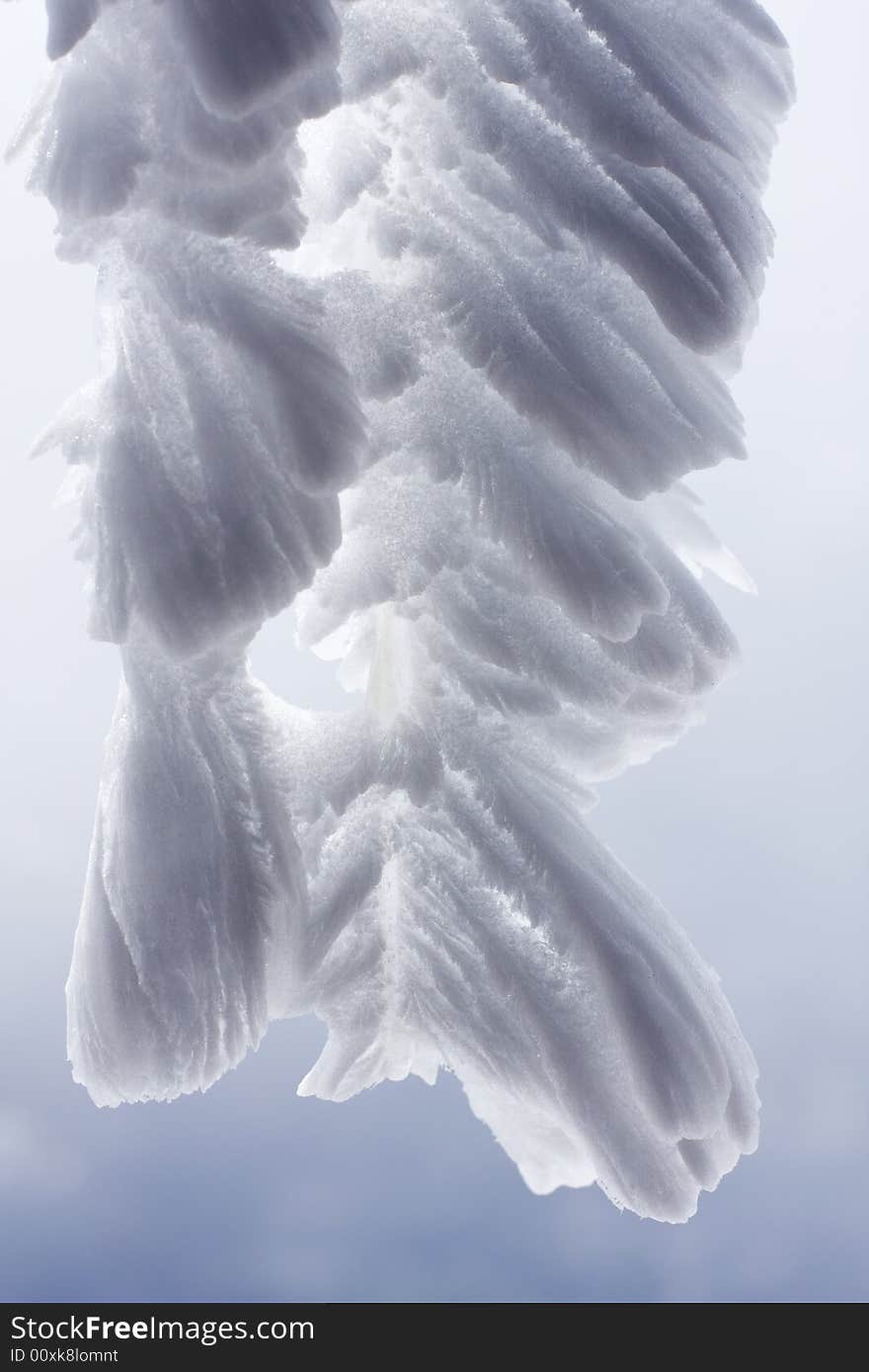 Icicles with wind driven snow deposits forming a feathery pattern. Icicles with wind driven snow deposits forming a feathery pattern