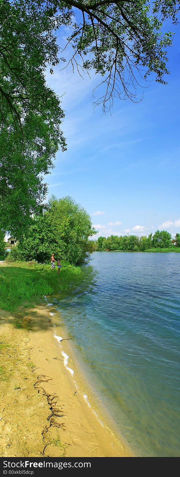 Lakeside with tree, green grass, path and nice blue sky. Lakeside with tree, green grass, path and nice blue sky