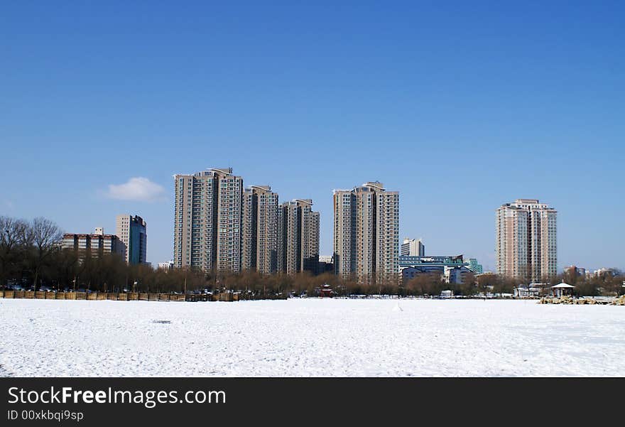 City with snow under blue sky in winter