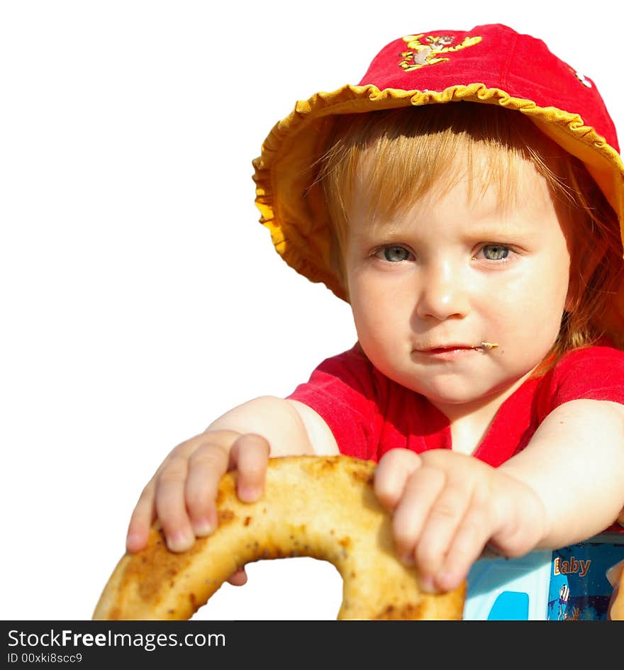 The little girl eats a bagel on a white background. The little girl eats a bagel on a white background