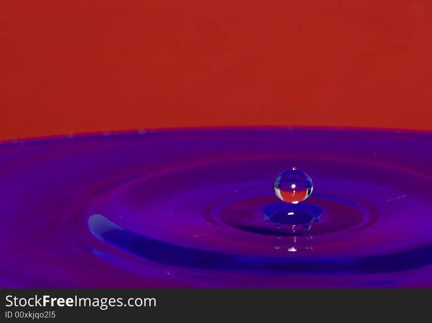 A single flying waterdrop with reflections. A single flying waterdrop with reflections