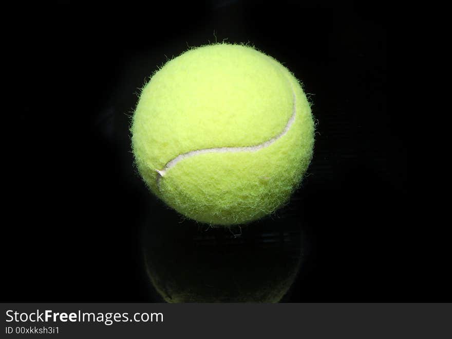 A tennis ball on black. A tennis ball on black