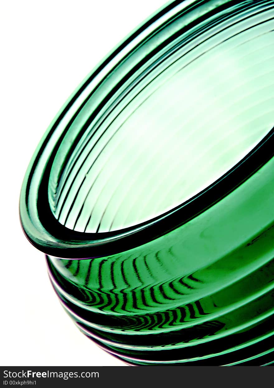 Abstract image of a green vase or bowl on a white background. The vase or bowl is textured.