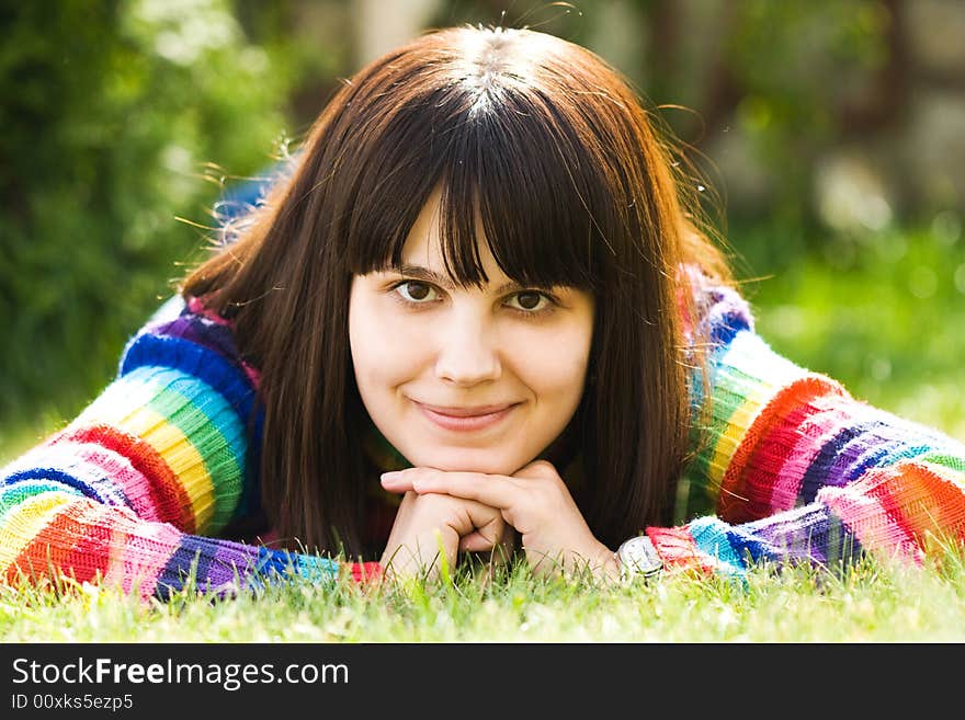 Beautiful girl lying on the green lawn. Beautiful girl lying on the green lawn