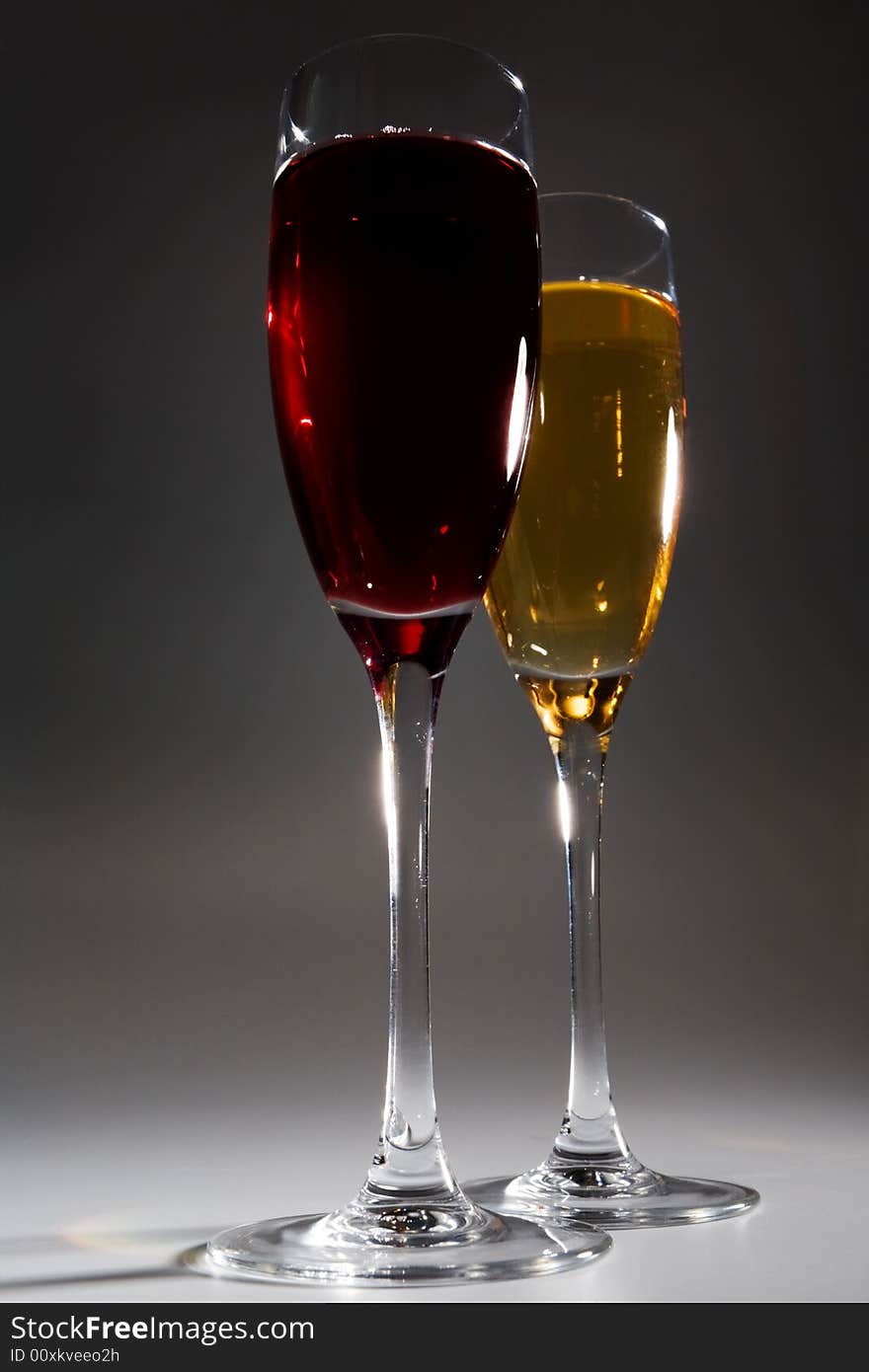 Two glasses with wine on a dark background