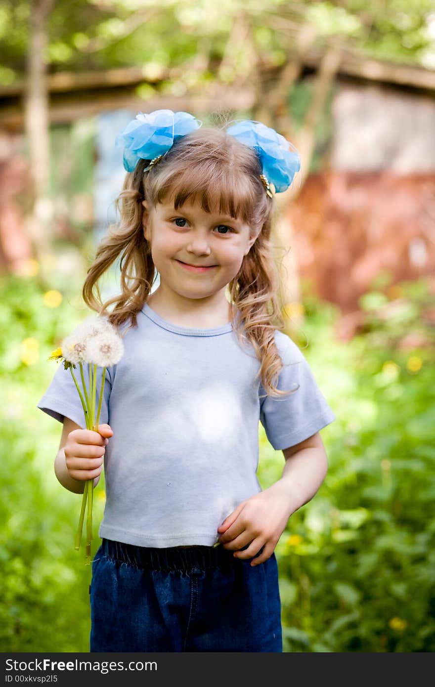 An image of a girl with dandelions. An image of a girl with dandelions