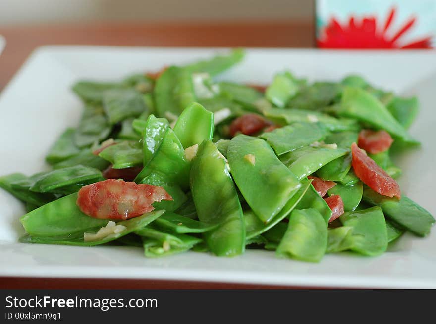 Stir fired snow peas with Chinese sausages. Stir fired snow peas with Chinese sausages.