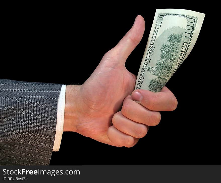 One hundred dollars in a hand of the man on a black background