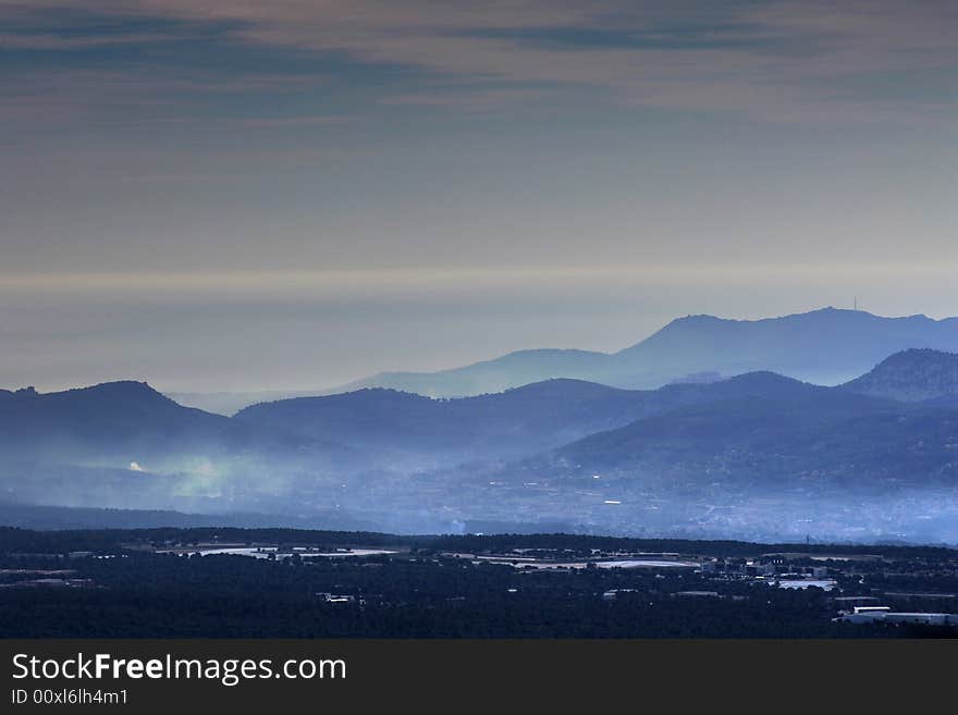 Landscape with mountains fog in a blue tone