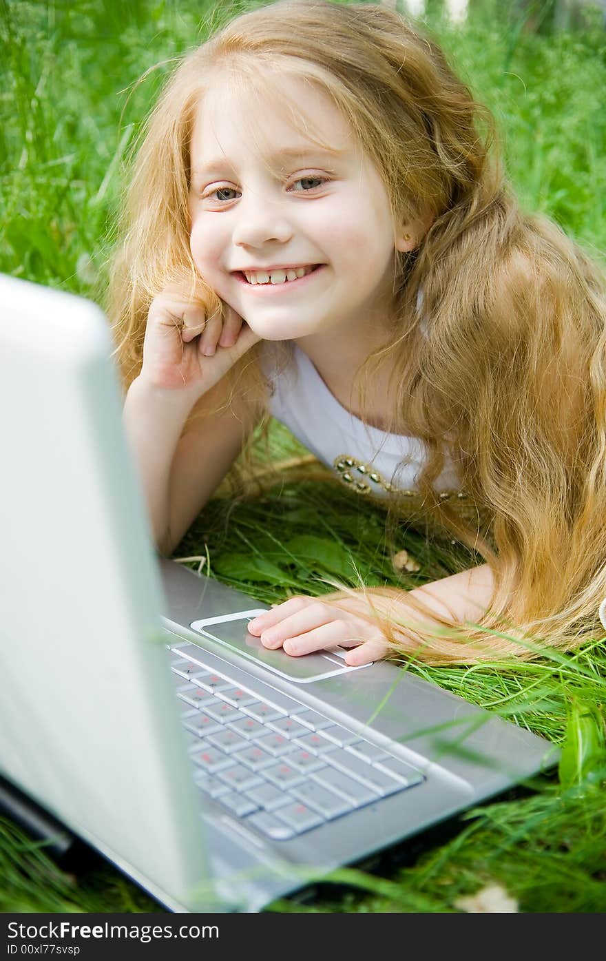 Smiling little girl with laptop