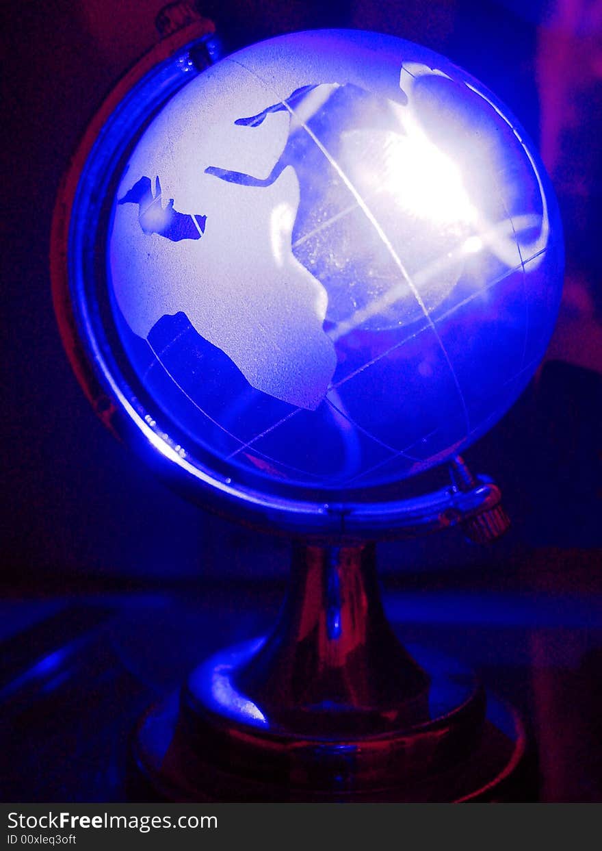 The globe in shining neon blue light. The globe in shining neon blue light