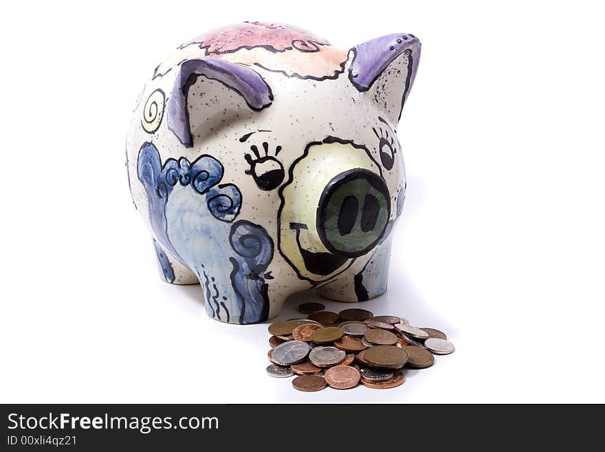 A handmade piggy bank on a white background with money in front of it. Hungre. A handmade piggy bank on a white background with money in front of it. Hungre