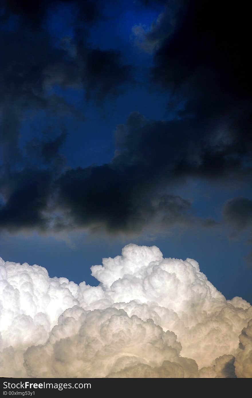 Deep blue sky with contrast between black and white clouds. Deep blue sky with contrast between black and white clouds