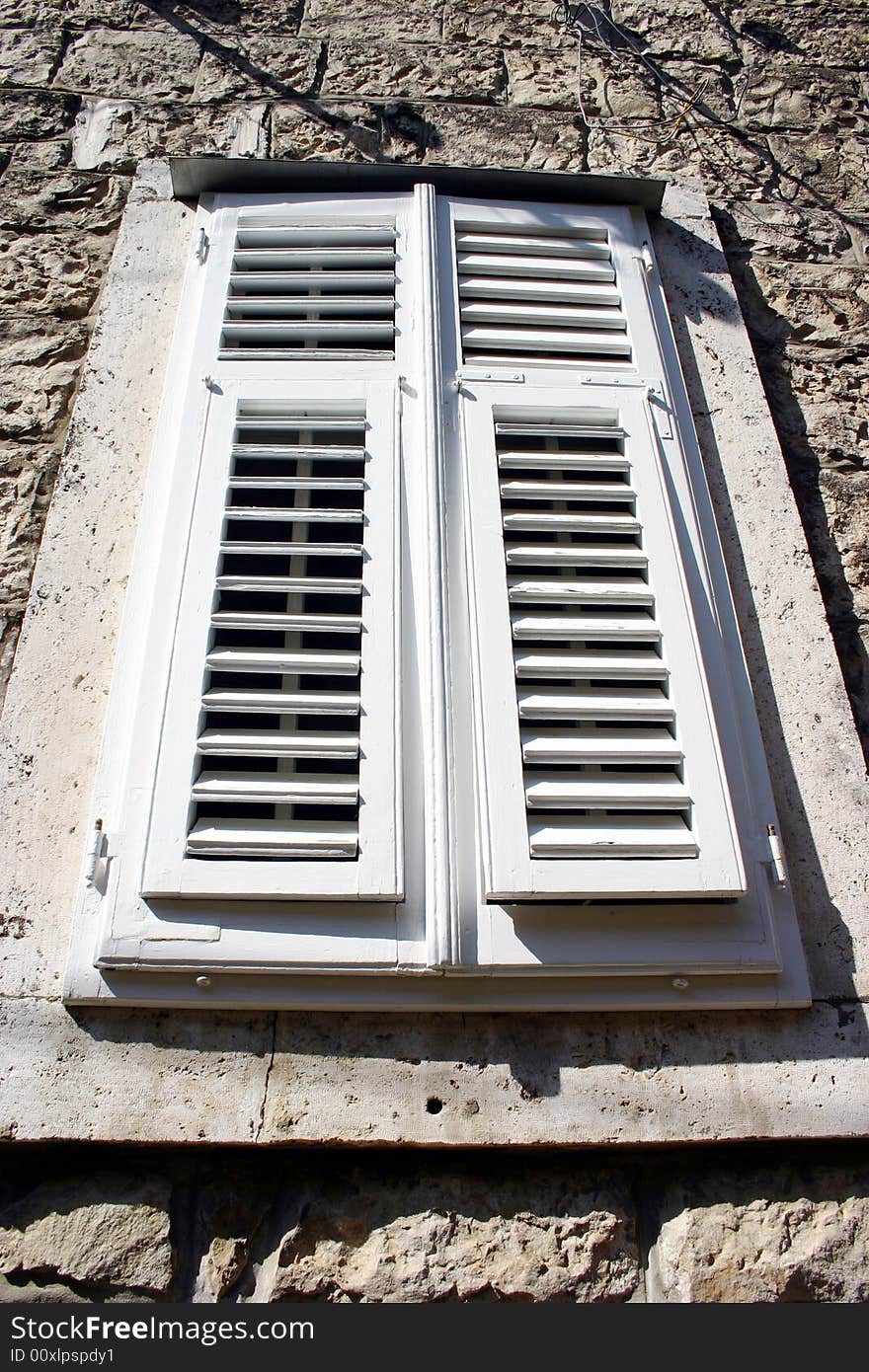 A shuttered  whitte window. Croatia. A shuttered  whitte window. Croatia.