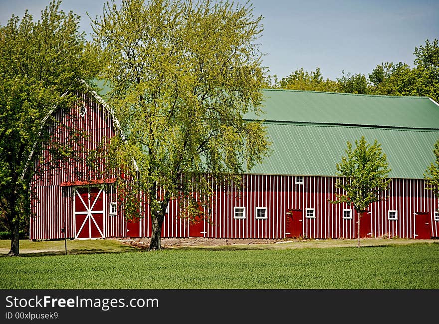 Unique red barn in late spring. Unique red barn in late spring.