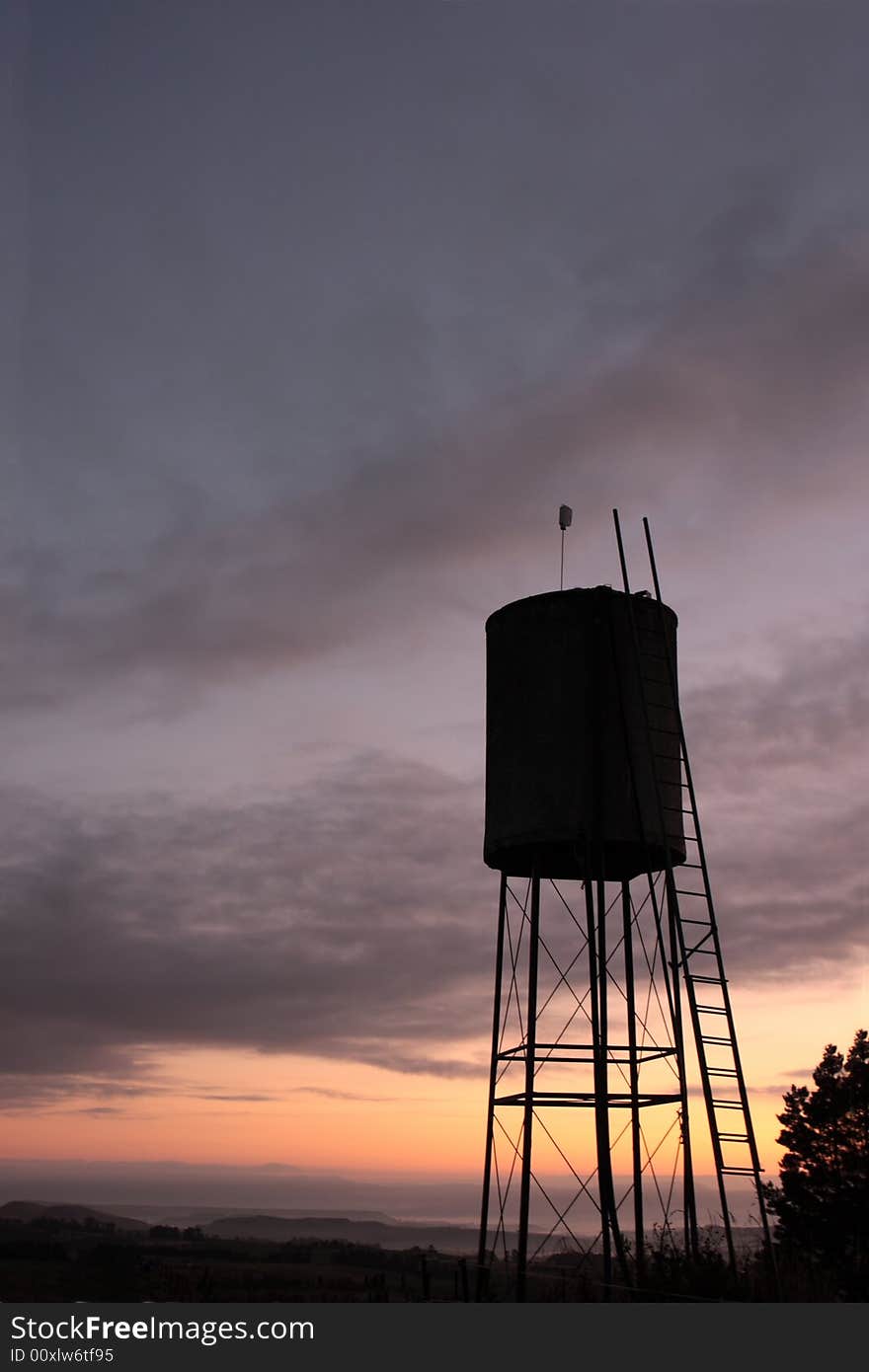 Silhouette of a rural water tank at dawn.  Dansey's Pass, Otago, New Zealand