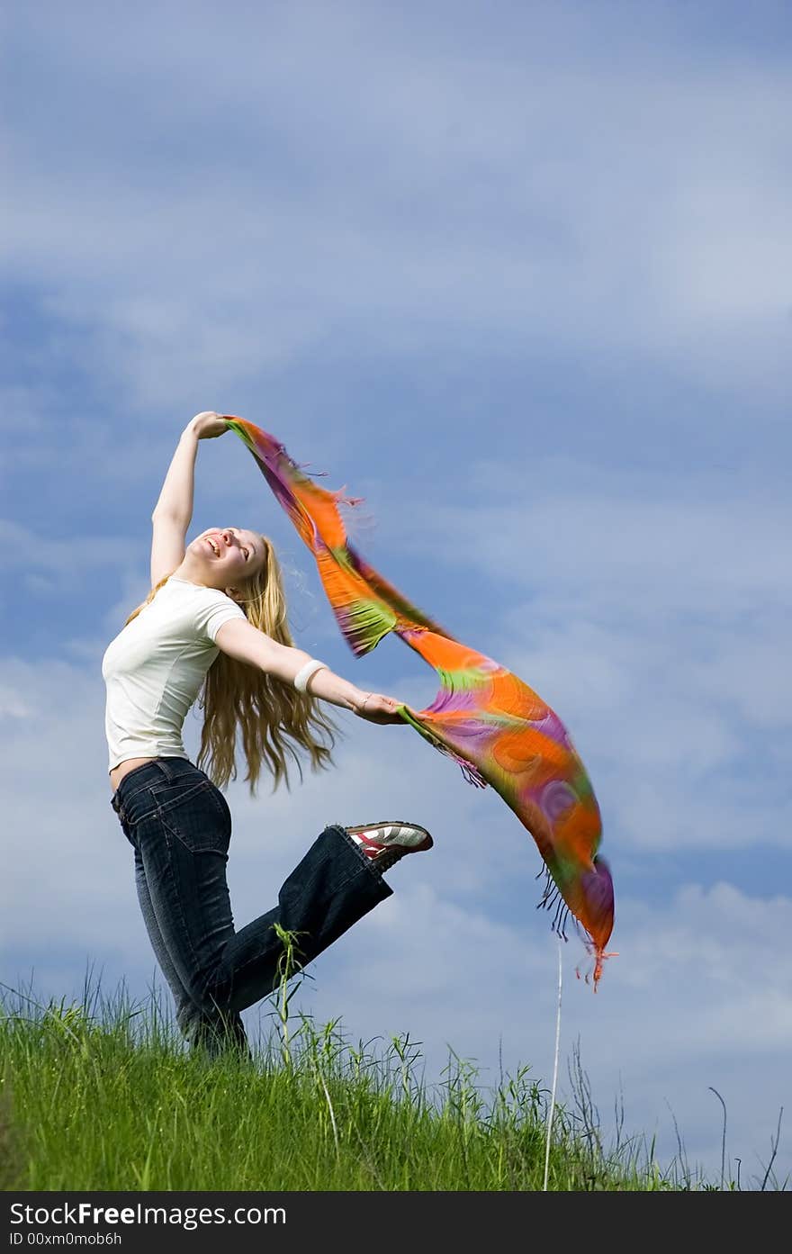 Girl with scarf stand on a wind