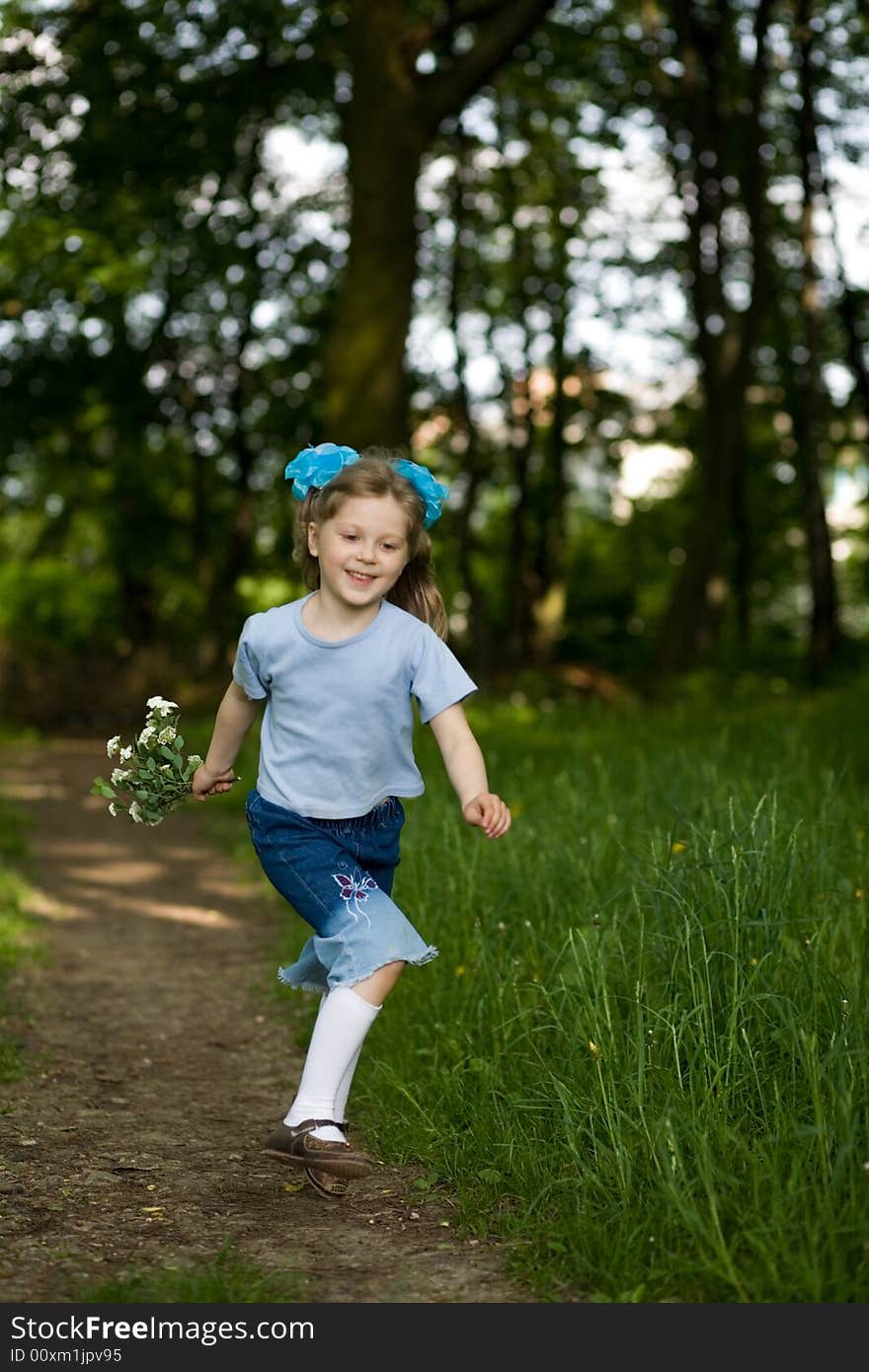 Happy girl running in a summer park