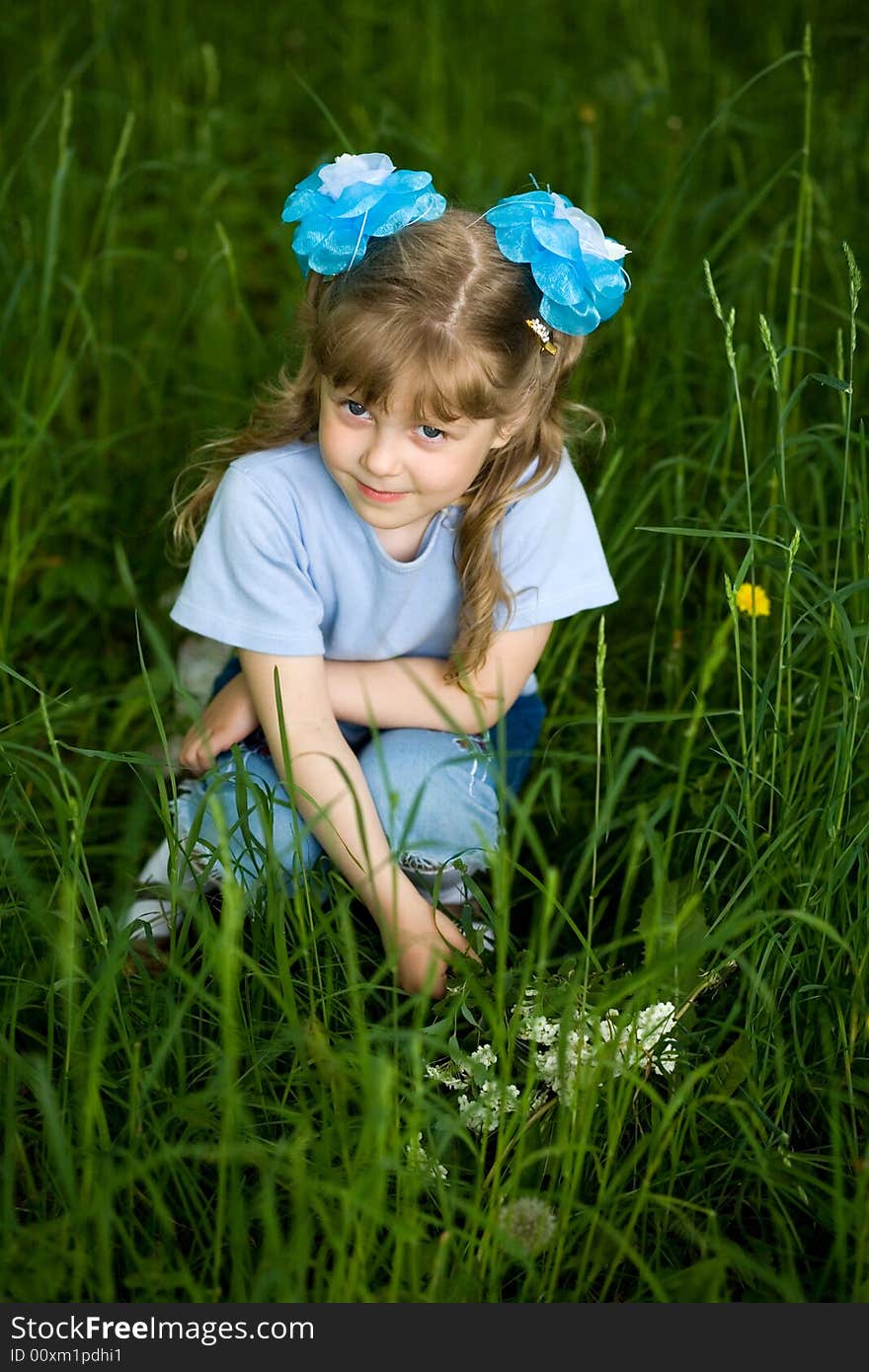 An image of a girl amongst grass. An image of a girl amongst grass