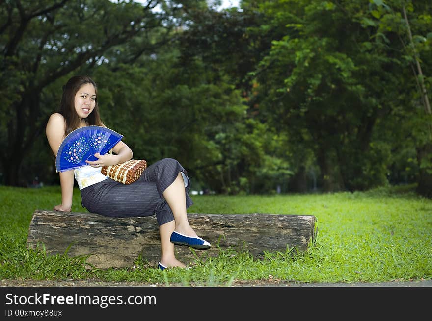 Smiling woman opening fan