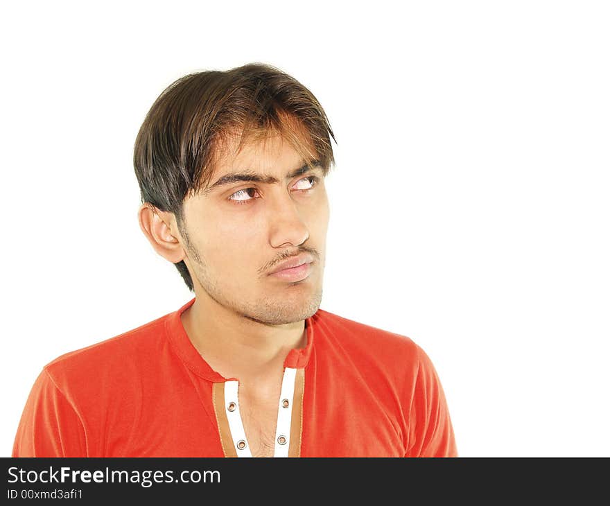 A young man looking off to the side with a serious expression on his face. . A young man looking off to the side with a serious expression on his face.