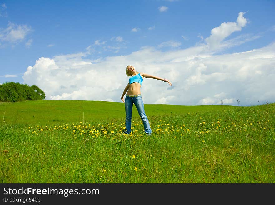 The girl jumping on a lawn