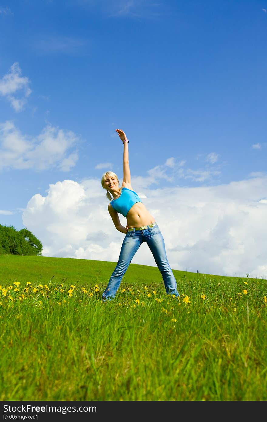 The girl jumping on a lawn