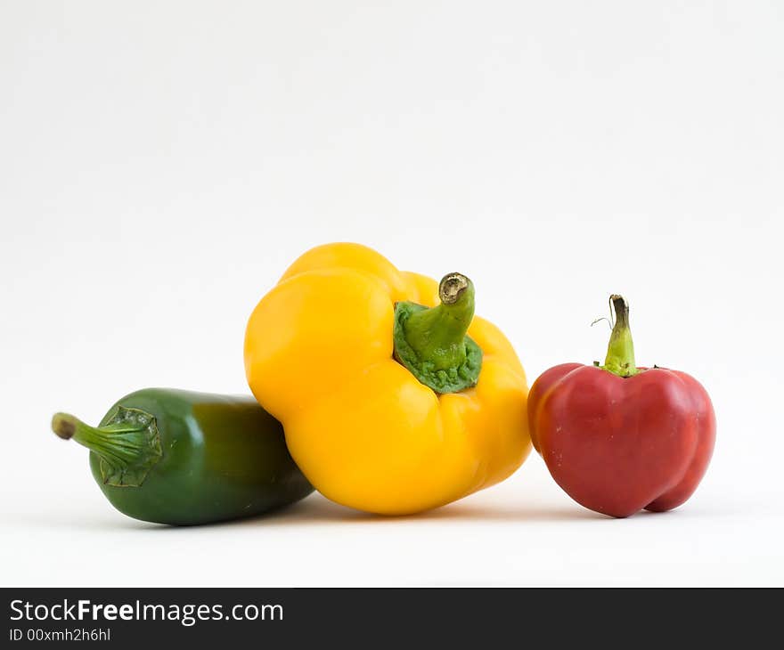 Still life of three differently shaped and colored chillies. Still life of three differently shaped and colored chillies