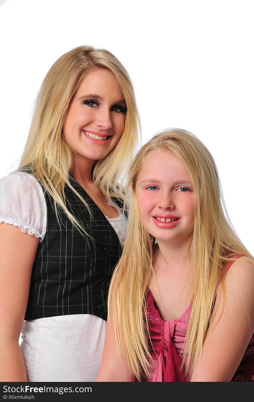 Two sisters smiling isolated on a white background