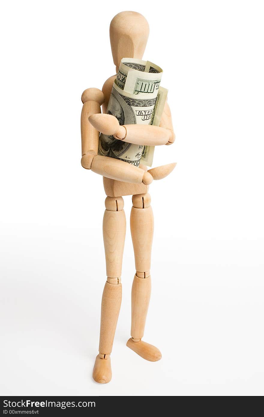 The wooden figure holds dollars.Isolated on white [with clipping path]. The wooden figure holds dollars.Isolated on white [with clipping path].