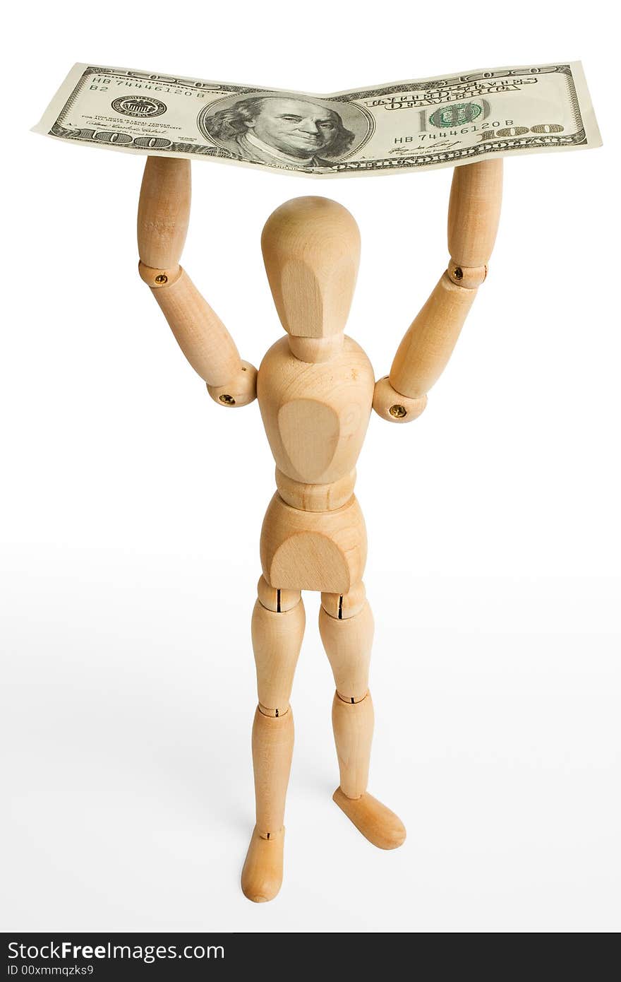 The wooden figure holds dollars.Isolated on white [with clipping path]. The wooden figure holds dollars.Isolated on white [with clipping path].