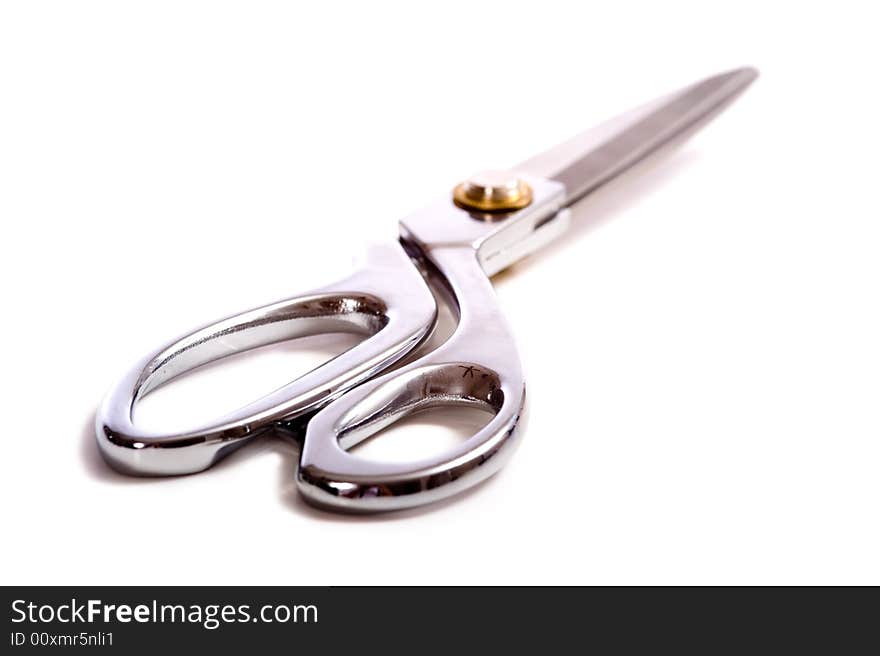 A pair of chrome dress shears or ceremonial scissors on a white background. A pair of chrome dress shears or ceremonial scissors on a white background