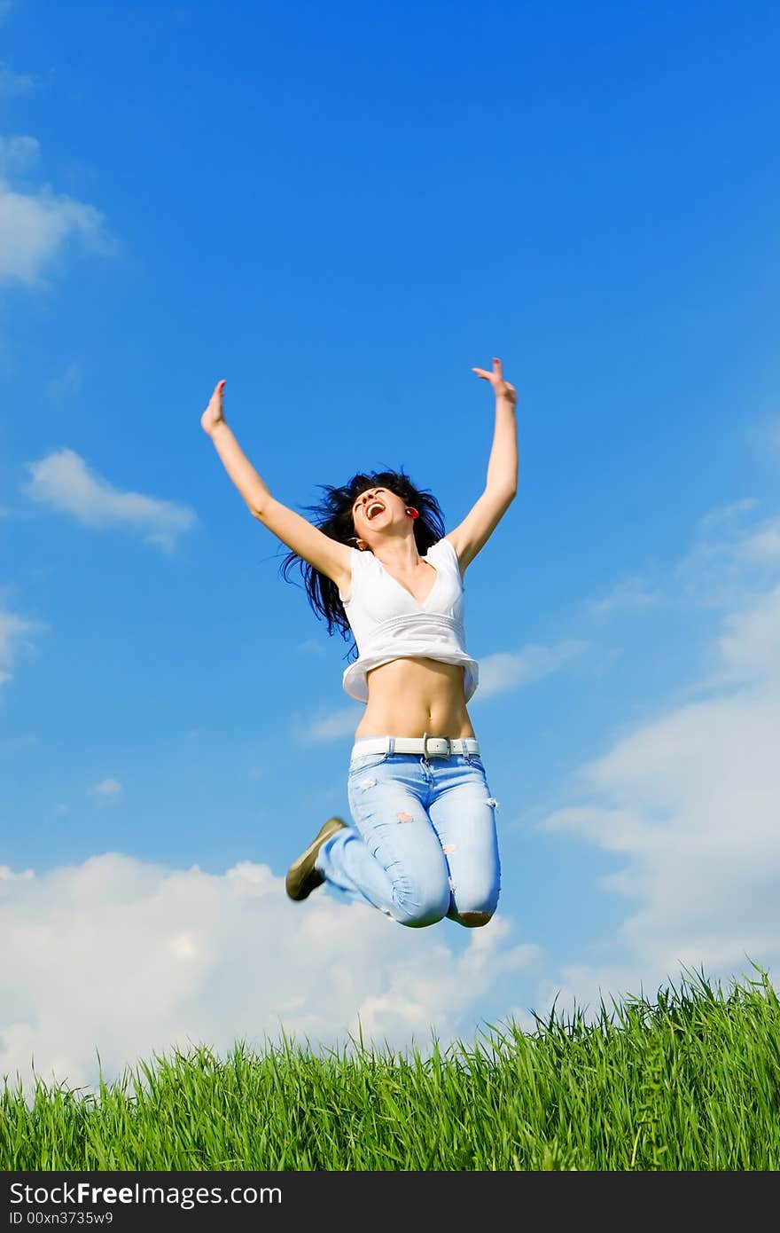 Happy young woman is jumping