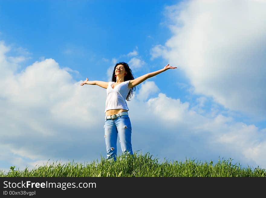 Happy young woman dreams to fly on winds