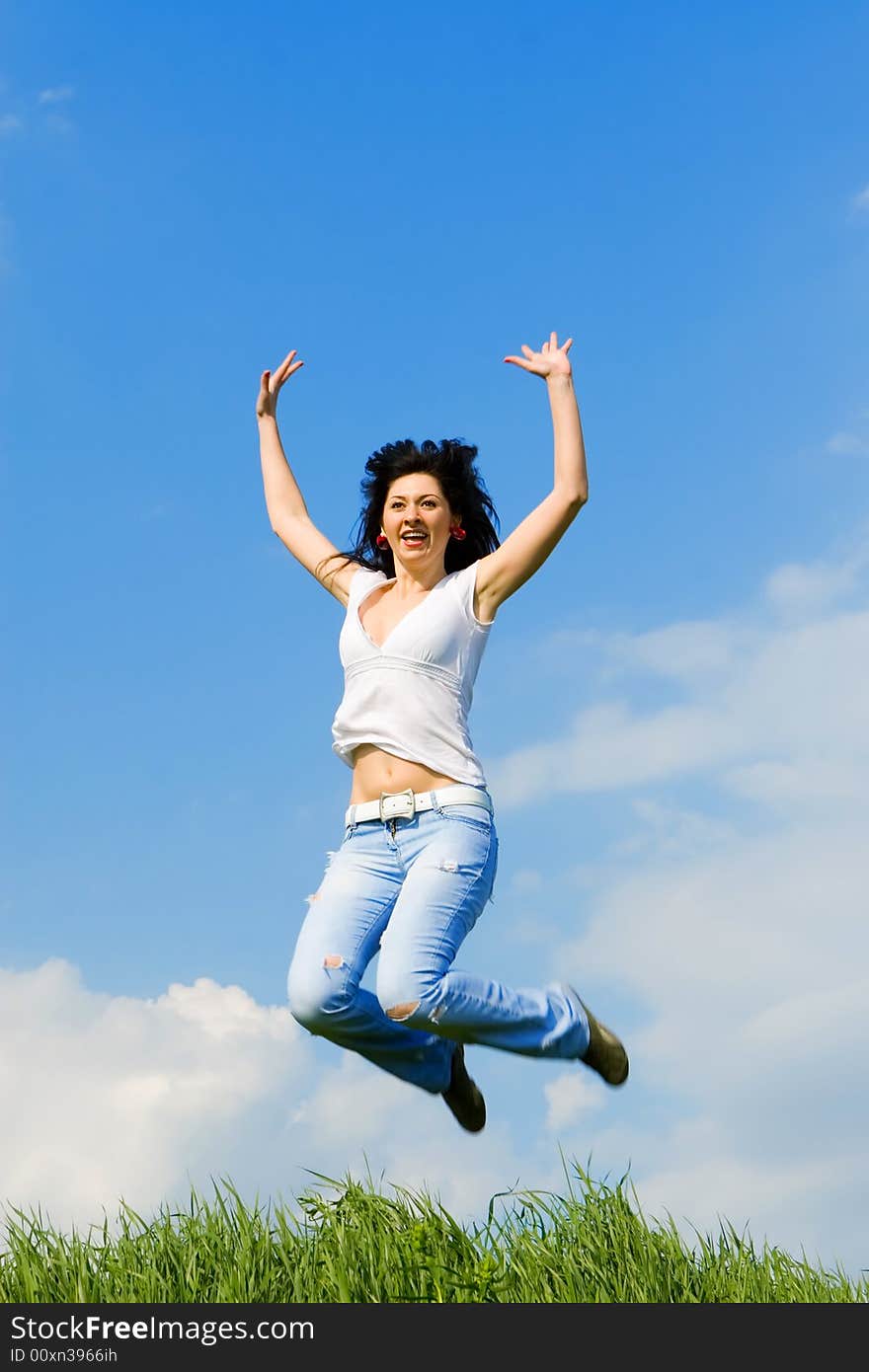 Happy young woman is jumping