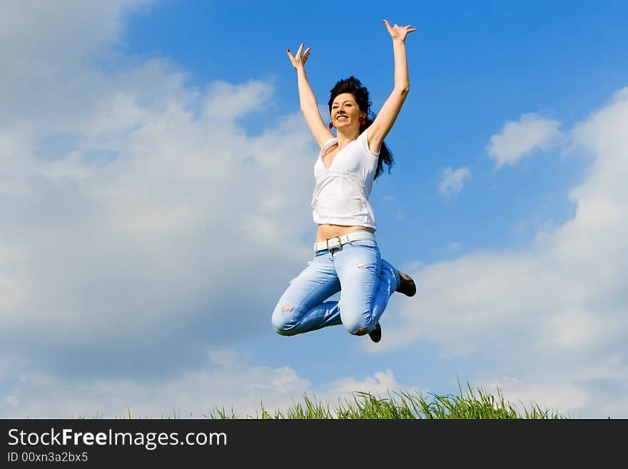 Happy young woman is jumping