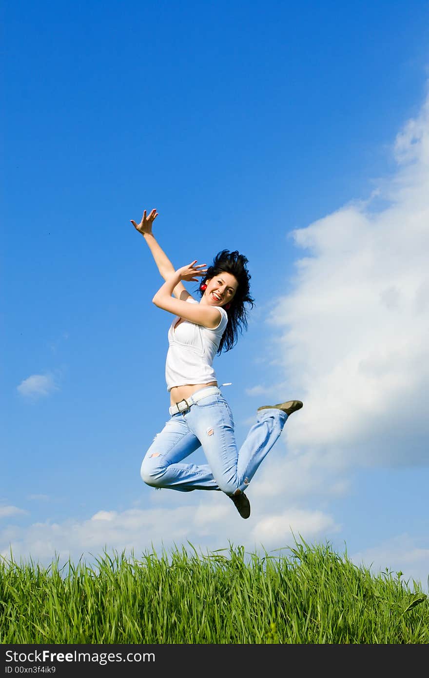 Happy young woman is jumping