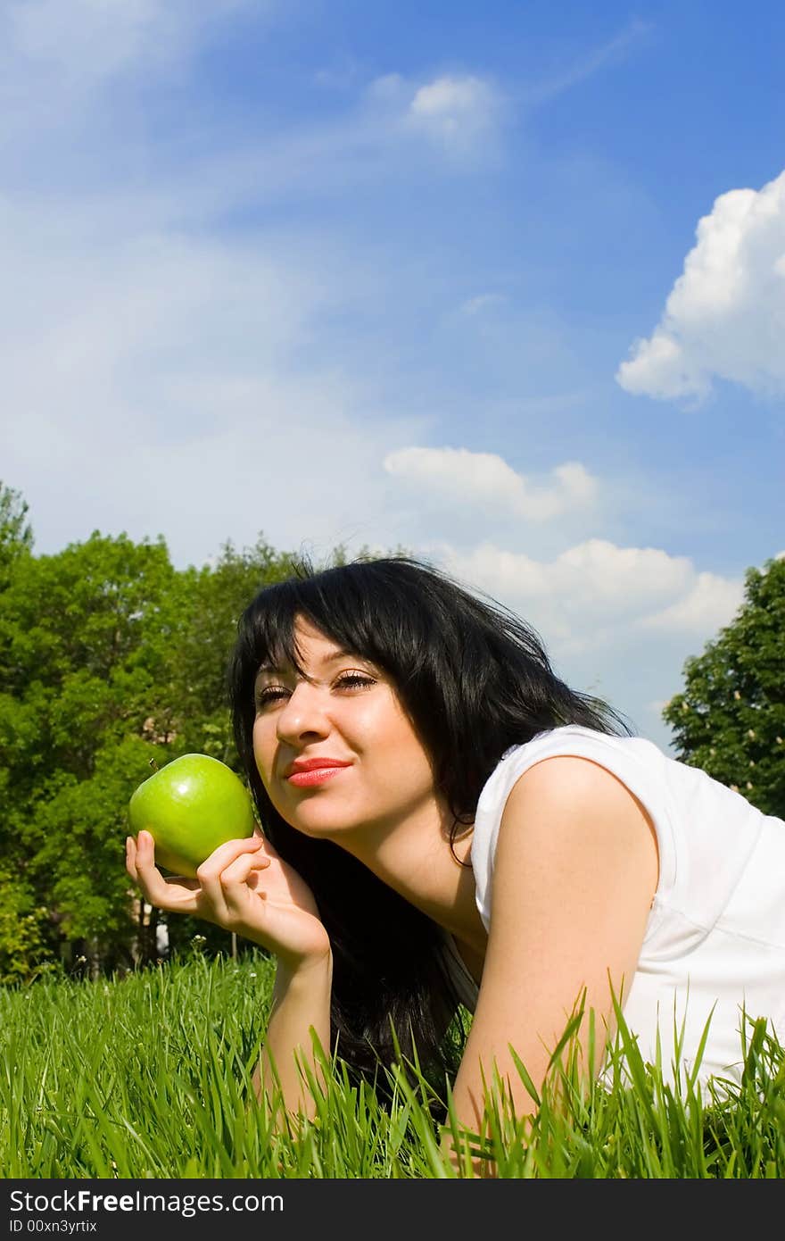 Pretty woman eating green apple